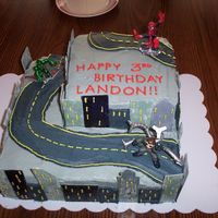 Spiderman Saves The City Spiderman birthday cake for a three year old boy. buildings on the sides of the cake are made of fondant.