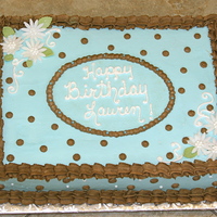 Blue & Brown Polka Dots 1/2 sheet of french vanilla cake with chocolate ganache filling, iced in buttercream with fondant daisies.