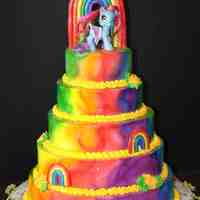 Rainbow My Little Pony 5 tier rainbow cake for my daughters 4th birthday. Iced in airbrushed buttercream with gumpaste rainbows. The pony is a toy (sigh)...my...