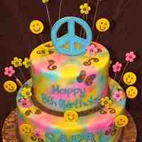 Peace Sign 12" & 9" vanilla WASC cake with oreo filling covered in MMF and airbrushed in the girls favorite colors. Fondant accents and...