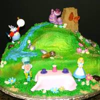 Alice In Wonderland 1/4 sheet with 6" carved round on top. Almond dream cake with chocolate mousse filling iced in buttercream. The lady supplied the...