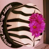 Zebra Cake This is a one-tier 3-layer white chocolate cake with raspberry filling and vanilla buttercream icing. The black zebra print and bottom rope...