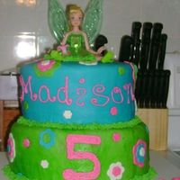 Tinkerbell Cake This cake was for my neice, she wanted a blue tinker bell cake with flowers. I think I filled the request :)