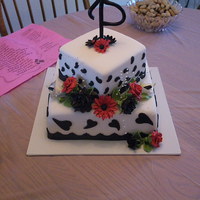 Black & White Beauty Butter cake with Strawberry filling . fondant accents and hand made gum paste flowers.