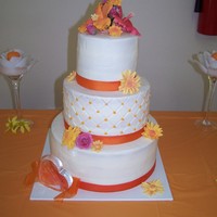 Orange/ White Dream Cake was French Vanilla with Buttercream Icing. All flowers were handmade from gumpaste.