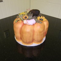 Fall Theme Baby Shower Pumpkin Pound Cake covered in fondant with flowers and accents from gum paste.