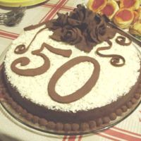 Cake With Modeling Chocolate Roses This is an orange cake with ganache, white chocolate curls and modeling chocolate roses and numbers