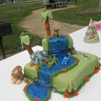 Jungle Cake Jungle cake. Covered in MMF. Fondant animals. Tinted gel water. Zebra print name. This was before I knew how to make supports for two tiers...