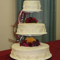 Son's Wedding Cake Last Fall This is the cake that My daughter and I made for my Son's wedding last fall. Buttercream frosting and silk flowers.
