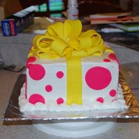 Dsc_01280011.jpg This cake was for a baby shower. Cake is yellow, icing is buttercream and bow and dots are fondant.
