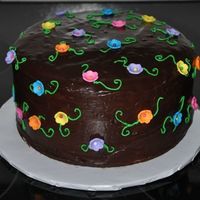 Chocolate Ganache Raspberry cake, covered in ganache, with fondant flowers