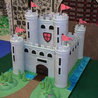 Medieval Castle 12" square and 6" square cakes (3 layers each). Castle sides are fondant/gumpaste mix and towers are covered Pringles cans....