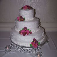 Calla Lilly Wedding Cake Chocolate cake covered with Butter cream frosting. Hand made gum paste Calla Lillies and leaves.