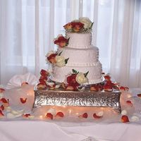 Wedding Cake This is a 3 tier fondant covered cake. It is decorated with butter cream dots and Fresh Roses. I made this cake for a friend of mine...