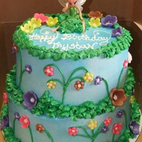 Tinkerbell Cake 2 tiered tinkerbell cake. Iced in buttercream w/ fondant flowers and buttercream leaves. Customer loved the cake and I have since gotten 3...