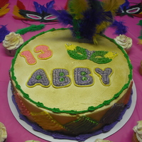 Mardi Gras Mardi Gras cake and cupcakes. Buttercream icing and designs, feathers from craft store.
