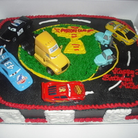 Cars Movie Cake Cars movie cake. Buttercream icing, buttercream designs. Purchased cars that went on top (customer request!)