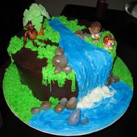 Go Diego Go 10" round covered in chocolate icing/ buttercream waterfall and grass. Animals fondant and Diego is plastic.