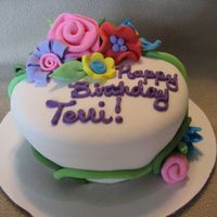 Whimsical Flower Cake 6" carved cake covered in fondant with whimsical fondant flowers