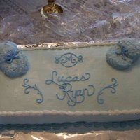 Baby Booties Shower Cake Shower cake. Booties are cupcakes cut up and covered in icing and coconut tinted.