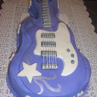 Hannah Montana Guitar Cake This was for my daughter's bday. Cake is covered in purple Buttercream icing and then decorated with MMF.