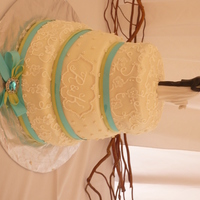 Brush Embroidery , Pearls This cake was three teirs of lemon cake with vanilla filling, covered in mmf and has wiltons sugar pearls and brush embrodiery. thank you...