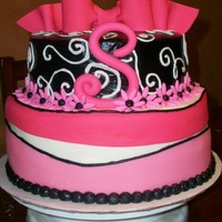 Bow, Swirls, And Daisies This cake was made to match her invitation. 10" strawberry on bottom 8" vanilla with strawberry filling on top. Butter cream...