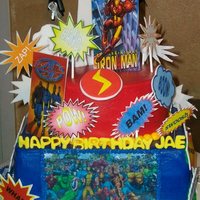 Marvel Superhero Cake Chocolate cakes with strawberry filling and butter cream frosting. There is an edible image on front and back of bottom layer. All...