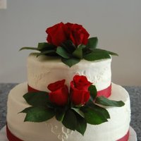 Red Rose Chocolate cake with whipped chocolate ganache filling. Butter cream icing and real roses.