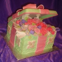 Bouquet In A Box 9" square (3 layers) covered in quilted fondant. Flowers are gumpaste/fondant mix. Lid and bow are gumpaste. Lid was formed on the...