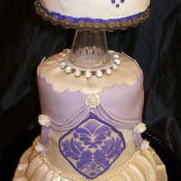 Adkinson Bday A surprise birthday cake! WASC with white chocolate truffle bavarian cream filling, covered in MMF and MMF accents. Tried my hand at a LOT...