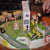 Mario Cart Wii Cake This cake was made for a friends birthday (He got a wii for his birthday..) So we actually put his Wii on the cake as a surprise. The...