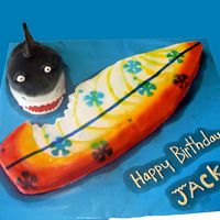 Surfboard And Shark Surfboard and Shark cake. The surfboard is 27" long. Surfboard is white cake covered in MMF and Shark is red velvet covered in MMF.