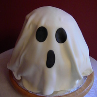 Booooooo.... Ghost b-day cake. 2 tiered cake iced in b/c and draped with fondant.