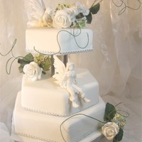 Fairy Wedding Cake In white and silver is this handmade fairycake with sugarpaste fairy&acute;s and roses.