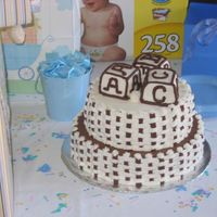 Brown And White Cake chocolate and butter cake on the tiers, bottom tier covered in chocolate buttercream and top tier covered in buttercream. Basket interwoven...
