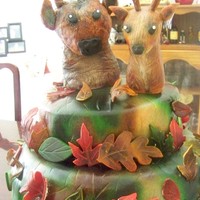 Mossy Oak Themed Wedding Cake Made this for my best friends wedding. Red velvet cake with cream cheese filling. THe buck and reindeer are rice crispie treats covered in...