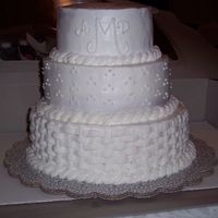 Most Meaningful Wedding Cake Red Velvet cake with buttercream filling and icing. Basketweave on bottom tier; dots on middle tier; top tier - plain with monogram.