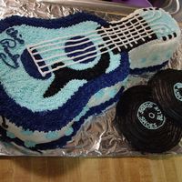 Elvis Guitar W/ Records Guitar cake pan, double layered with buttercream icing. Records are Peanut butter fudge with buttercream icing.
