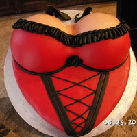 Corset This cake was for a friends birthday. The cake was strawberry and cheese cake frosting and all decorations was fondant.