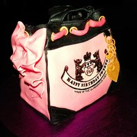 Juicy Couture Purse Cake used loaf pan to bake cake then carved to get the desired shape, iced in bc, covered in mmf, accents in gumpaste. label made using edible...