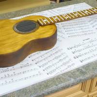 Guitar Cake Sheet cake carved by hand with a handrawn template. Painted with food coloring. The cake board is foam core covered in printed guitar sheet...