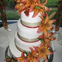 Amanda.jpg Lemon cake decorated with lemon bc. Green and burnt orange ribbon and fresh daylilies. 6", 8", 10" and 14". Thanks for...