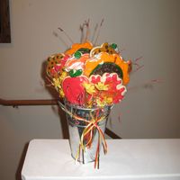 Fall Cookie Bouquet Sugar cookies with RI. Included are apples, pumpkins, acorns, sunflowers, maple leaves and oak leaves. Used 1/2 floral foam to insert...
