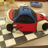 Race Car My first attempt at a sculpted cake & also first fondant cake. This was for kids at church...I ran out of time & wanted to do more...