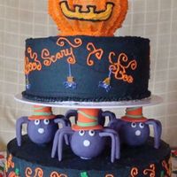 Spooky Spiders I made this cake for a Halloween party, the idea came from a Wilton magazine. The bottom tier was white cake with halloween colored jimmies...