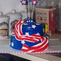 100_1480.jpg A 70th Birthday cake for a very patriotic man. Devil's food with chocolate truffle filling. 9in and 6 in. TFL