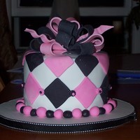 Kim's Birthday Birthday cake for a very nice co-worker. Double chocolate cake with peanut butter filling. Gumpaste bow, fondant covered with fondant...