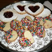 Linzer Cookies Linzer cookies with ends dipped in chocolate and covered with sprinkles and Linzer Sandwich cookies.
