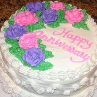 Gluten Free Anniversary Gluten Free chocolate cake with raspberry filling, whipped cream icing, buttercream decorations